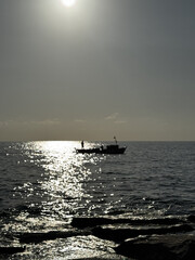 silhouette of a ship at sea sunset