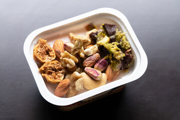 Greek yogurt with dried fruit and nuts. Simple snack with protein and healthy fat.