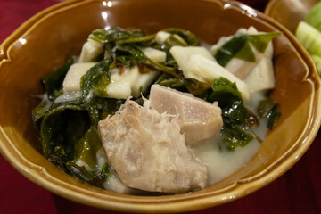 Melinjo leaves with taro in coconut milk soup; traditional meals in the south of Thailand.