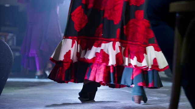 Graceful women in vibrant dresses dance together on stage
