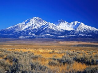 Fototapeta premium majestic snow-capped mountains under a clear blue sky