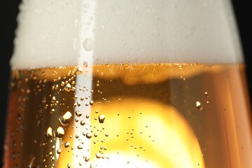Glass of beer with condensation drops, macro view