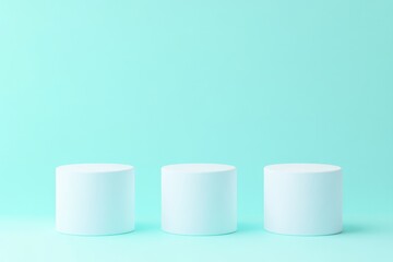 Three light blue cylindrical podiums on a light blue background.