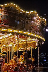 Cheshire, United Kingdom, 2024: Close up of carrousel ride at fair, red tint, vintage look, with...