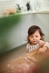 cute little child girl cooking gingerbread cookies .