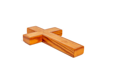 Wooden cross lies on a white surface
