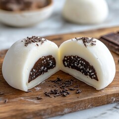 Fototapeta premium A mochi ice cream piece with chocolate filling, sliced in half to show the creamy center.