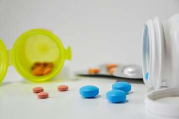 Pills and containers in white background