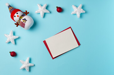 Blank card with Christmas decor on blue background. Space for text. Flat lay, top view