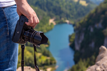 Male hand with camera in nature
