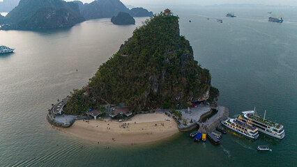 Naklejka premium Aerial view of Ti Top Beach island, Ha Long Bay, Halong Bay is a UNESCO World Heritage Site and popular travel destination, Vietnam. Cruise ships and islands. Sunset