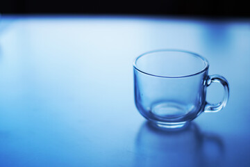 empty glass of water cup on blue background