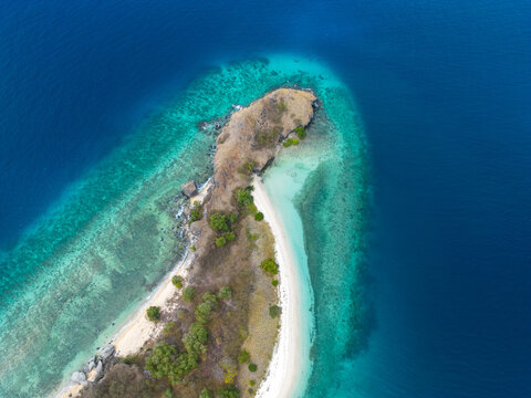 Aerial view of a beautiful tropical island surrounded by clear blue waters.