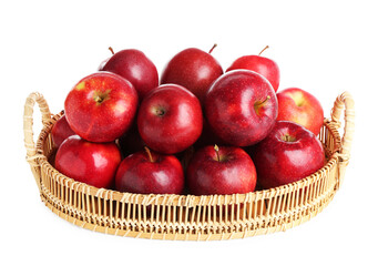 Fresh ripe red apples in wicker tray isolated on white