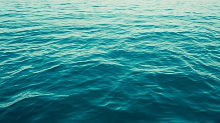 Obraz premium A serene view of calm ocean water, showcasing gentle waves and a tranquil atmosphere.