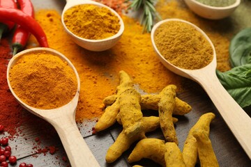 Different aromatic spices on wooden table, closeup