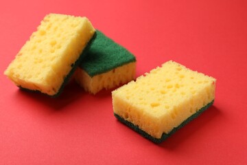 Soft sponges on red background. Cleaning tool