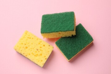 Soft sponges on pink background, top view. Cleaning tool