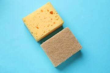 Soft sponge on light blue background, top view