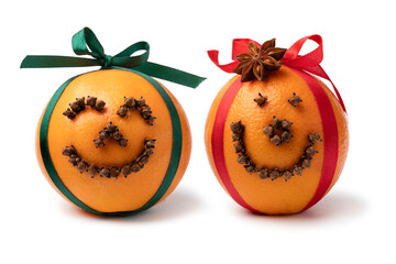 Pair of traditional orange happy Christmas pomanders isolated on white background close up