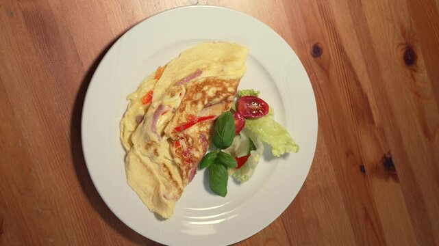 Omtelle is Served for Breakfast with Salat, Smooth Food Shot in a restaurant or Cafe, Morning Meal.