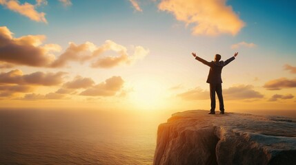 Fototapeta premium dynamic image of a businessman standing on a cliff edge, arms open to the wind, symbolizing freedom and fearless achievement