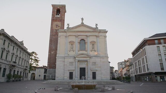 Historic center of an Italian city with fountain and church. Gallarate, square della Libert&agrave; with the Basilica of Santa Maria Assunta, On the left is the town hall. Province of Varese, Italy    