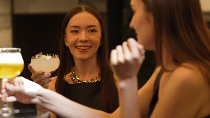 Enjoy drinking beautiful woman mixed vodka cocktails at luxurious counter bar toasting with friends scene capture essence nightlife luxury with special highlighting refreshment friendship. Vinosity.
