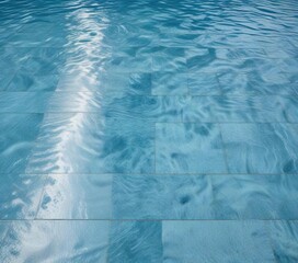 Obraz premium Pattern of blue floor mat reflected on wave pool water surface, water surface, background