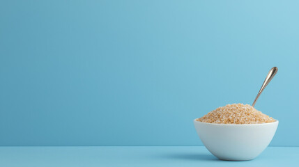 Bowl of sugar on blue background, representing excess sweetness and indulgence