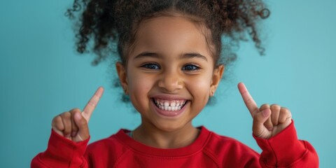 Young girl with curly hair gives a peaceful gesture, suitable for child-focused or educational content