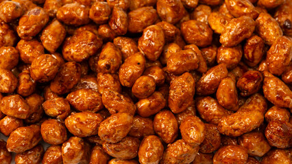 Tasty sweet roasted peanuts as a background.