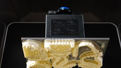 Advancements in dental technology highlight a cutting edge 3d printer producing dental prostheses. Rapid innovations in dentistry improve precision and efficiency in oral health solutions. Modern