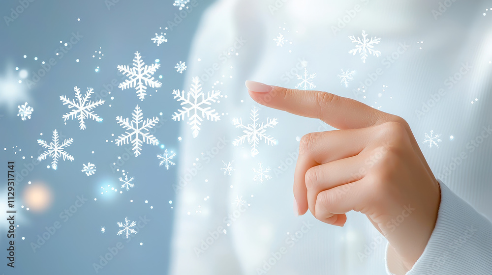 Poster Creating winter magic with a finger touch and falling snowflakes in a serene blue background