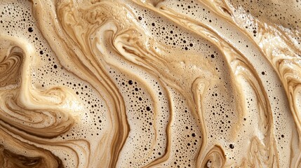 Creamy coffee foam swirls and mixes, creating mesmerizing abstract patterns, capturing the essence of a freshly brewed beverage in a macro close-up