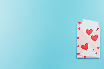 Valentine's Day envelope with hearts on a blue background offering copy space for romantic messages and greetings