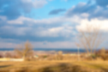 Blurred spring city background with clouds