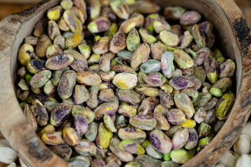 geschälte Pistazien Pistacia vera auf Olivenholz