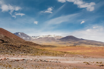 Salt flats and volcano mountains on altiplano high altitude plains in Chile. Atacama desert landscape. Salt lakes in San Pedro de Atacama altiplano landscape at Piedras Rojas natural reserve