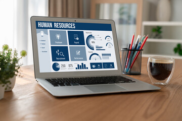 Human resources management software on computer screen helping human resources employee to manage recruitment, payroll, staff searching and KPI evaluation snugly