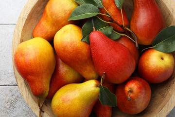 Ripe juicy pears on light tiled table, top view