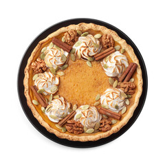 Homemade pumpkin pie with whipped cream, seeds and cinnamon isolated on white, top view