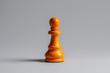 A wooden chess piece sits alone on a gray surface