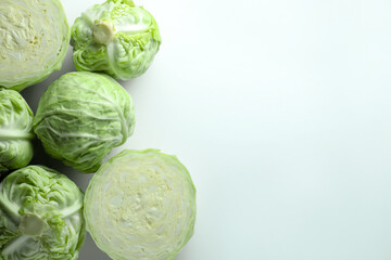Raw green cabbages on white background, flat lay. Space for text