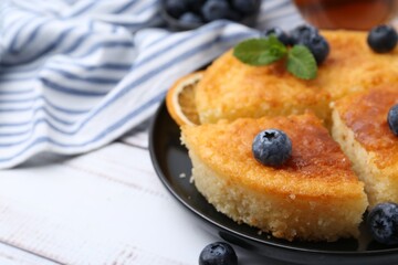 Delicious semolina cake with blueberries on white wooden table, closeup. Space for text