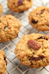 Delicious oatmeal cookies with raisins and nuts on table, closeup