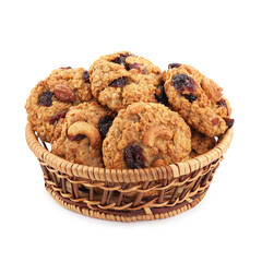 Delicious oatmeal cookies with dried cranberries and nuts in wicker basket isolated on white