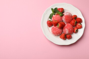 Delicious mochi, strawberries and mint on pink background, top view. Space for text