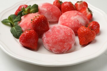 Delicious mochi, strawberries and mint on white table, closeup