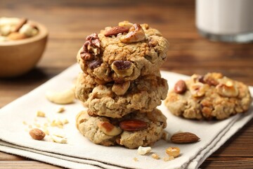 Tasty cookies with nuts on wooden table, closeup